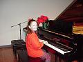Stephanie Williams sitting at the piano at her Dec 4, 1999 piano recitial 3